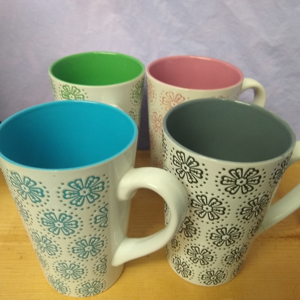 Four Grayson Hall coffee cups.